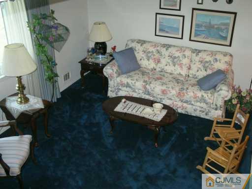 6 Magee Road Edison, NJ 08817 - Photo 2 of 8 a living room with furniture and a table