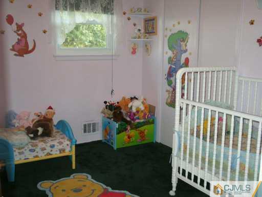 6 Magee Road Edison, NJ 08817 - Photo 6 of 8 a bedroom with a bed and a window