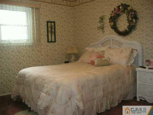 6 Magee Road Edison, NJ 08817 - Photo 7 of 8 a bedroom with a bed and a window