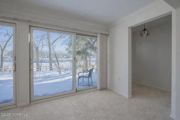 a view of an empty room with a fireplace and a window