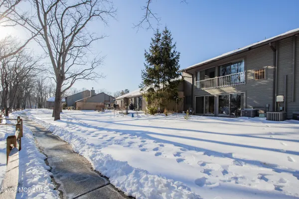 a view of a building with snow on the road