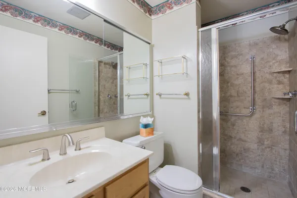 a bathroom with a sink toilet and shower