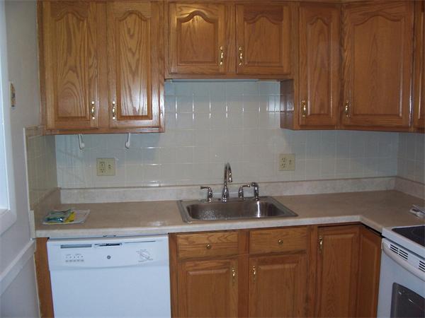 A3 Colonial Drive, Unit 2 Andover, MA 01810 - Photo 2 of 11 a kitchen with stainless steel appliances granite countertop a sink and cabinets