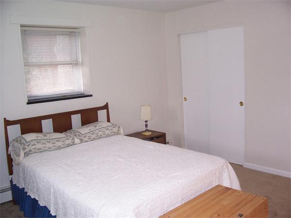 A3 Colonial Drive, Unit 2 Andover, MA 01810 - Photo 9 of 11 a bedroom with a bed and a window