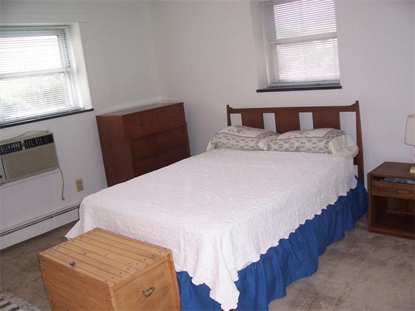 A3 Colonial Drive, Unit 2 Andover, MA 01810 - Photo 10 of 11 a bedroom with a bed and wooden floor