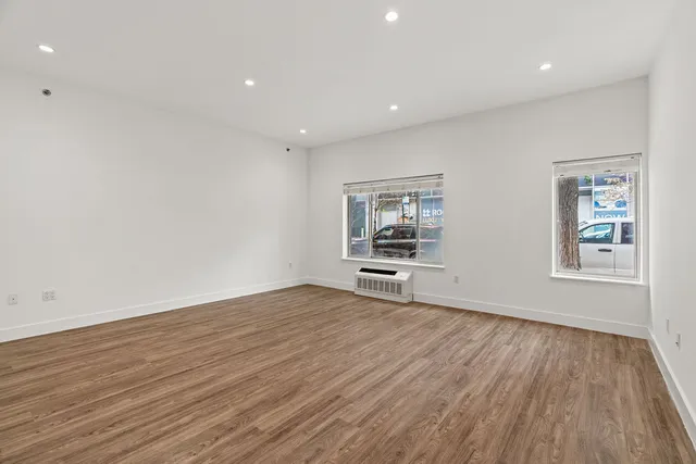 a view of room with window and wooden floor