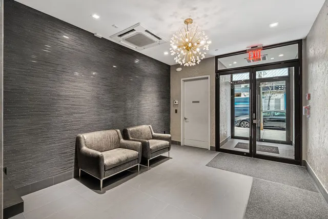 a living room with furniture and a chandelier