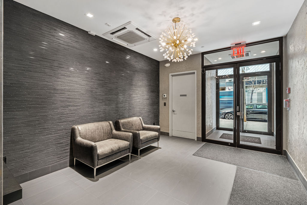 Undisclosed Address Queens, NY 11101 - Photo 20 of 21 a living room with furniture and a chandelier