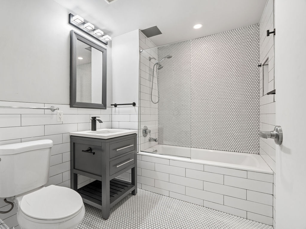 Undisclosed Address Queens, NY 11101 - Photo 5 of 21 a bathroom with a sink a toilet and shower