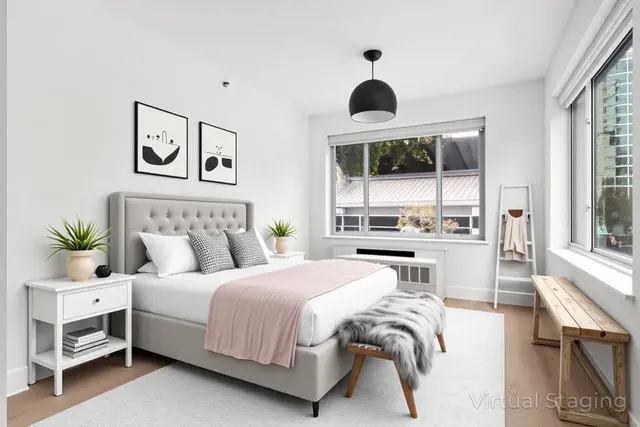 a bedroom with a large bed and a large window