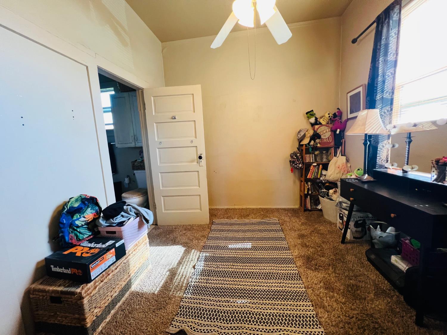 612 16th Street Modesto, CA 95354 - Photo 6 of 19 interior space featuring dark colored carpet and ceiling fan, front house bedroom 1