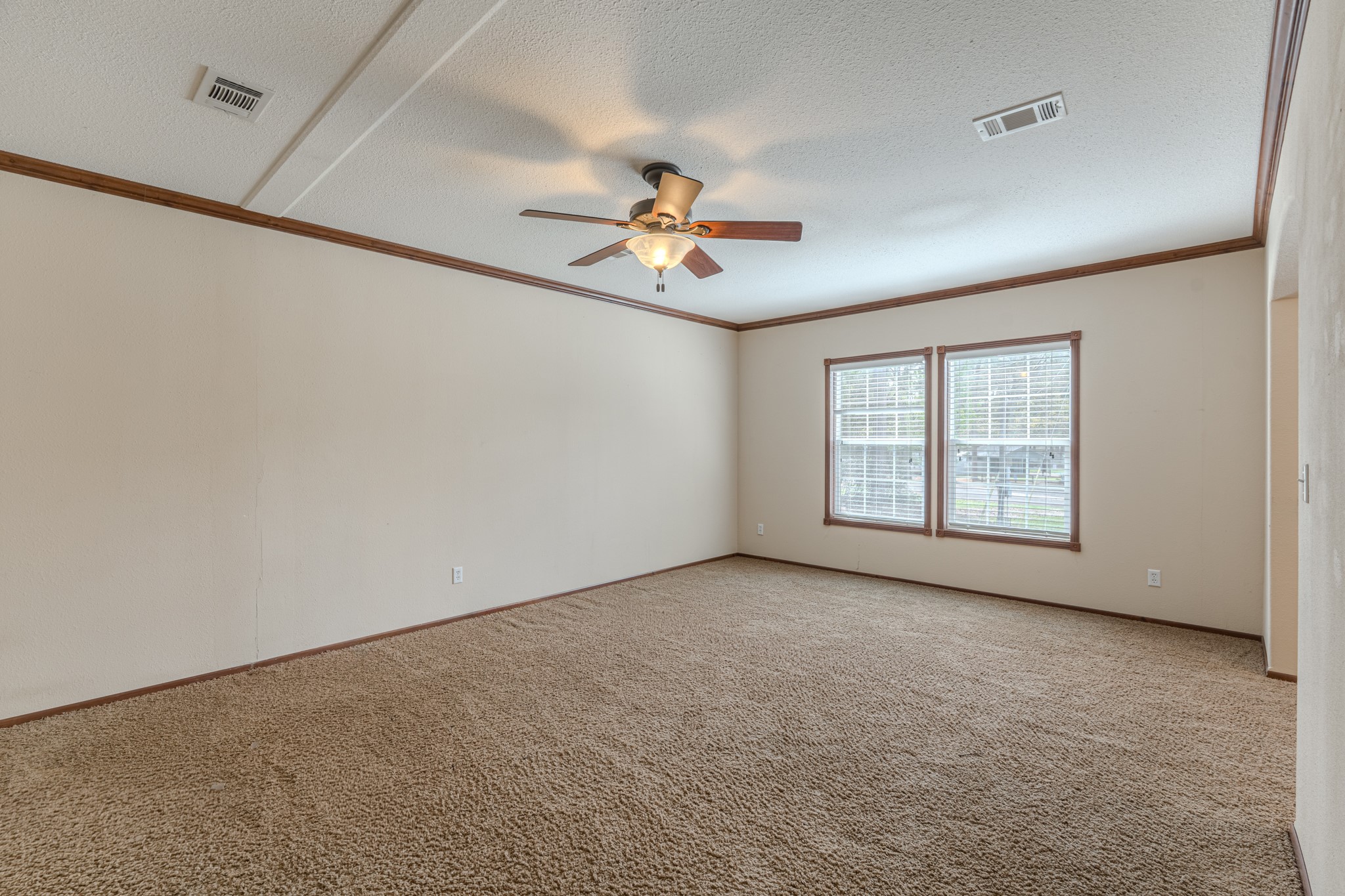 115 Canadian Drive Trinity, TX 75862 - Photo 21 of 42 Fourth bedroom with a ceiling fan with light. Large windows offer natural light, making it bright and inviting.