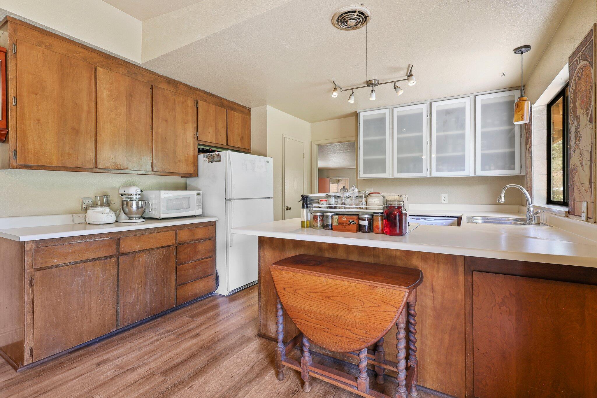 7741 Placer Road Redding, CA 96001 - Photo 12 of 24 a kitchen with a sink refrigerator and cabinets