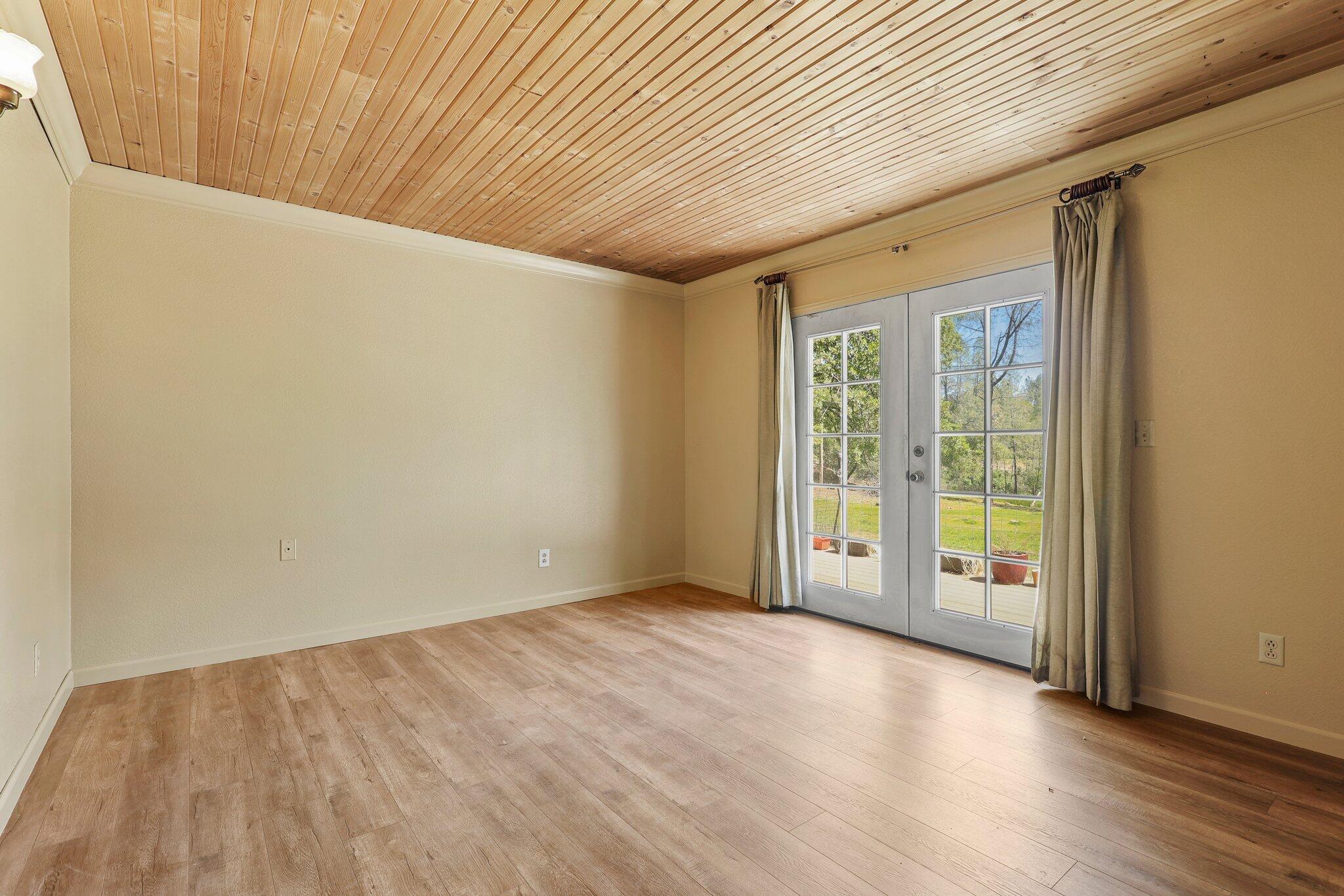7741 Placer Road Redding, CA 96001 - Photo 20 of 24 a view of an empty room with wooden floor and a window