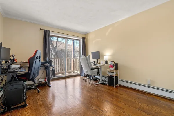 a view of a workspace with furniture and a window