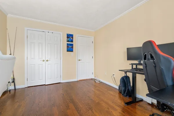 a view of a livingroom with wooden floor and furniture