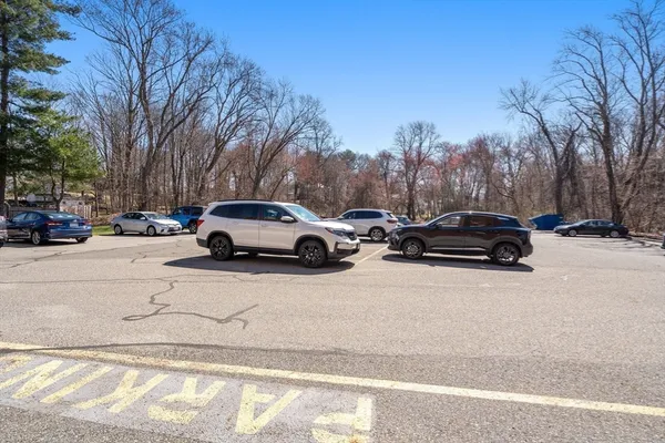a view of cars parked on the side of a street