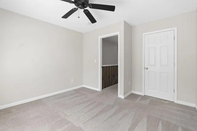 an empty room with closet and windows