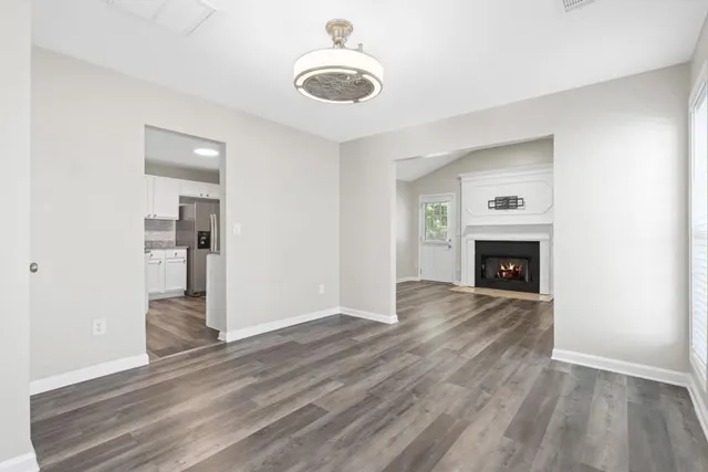 wooden floor in an empty room with a fireplace