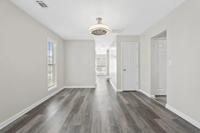 a view of a room with wooden floor and window