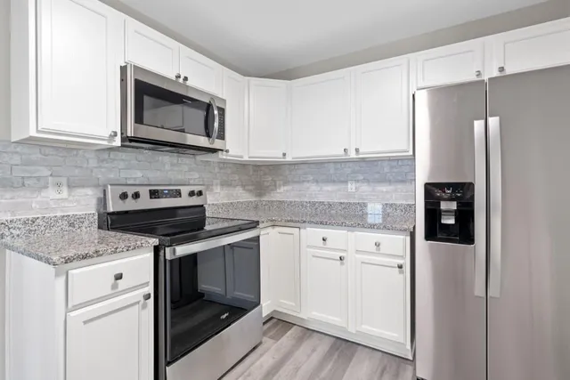 a kitchen with a stove microwave and refrigerator