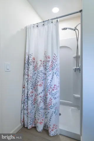 a bathroom with a shower and a mirror