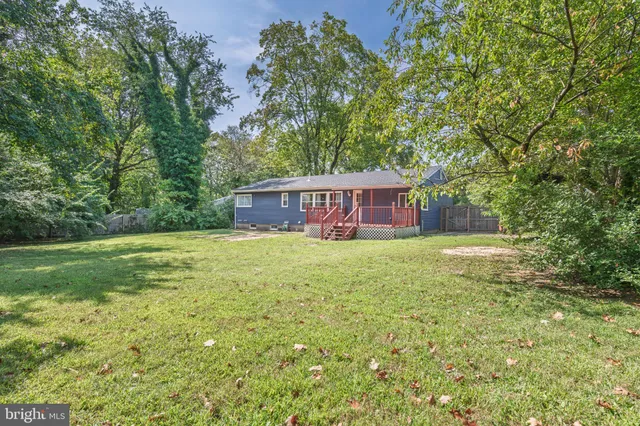 a view of a house with a yard and sitting area