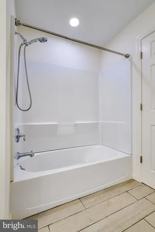 a bathroom with a shower and a bath tub