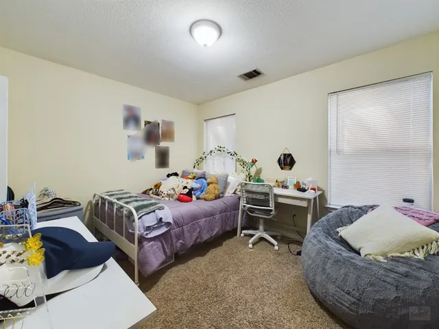 a bedroom with furniture and a window