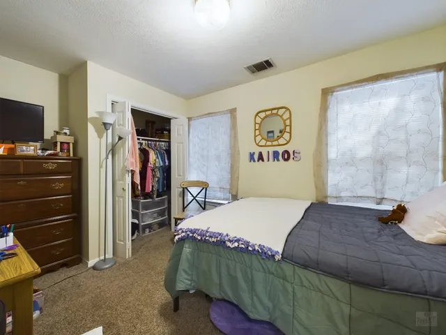 a bedroom with a bed and a television