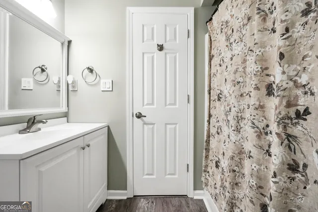 a bathroom with a granite countertop sink and a mirror
