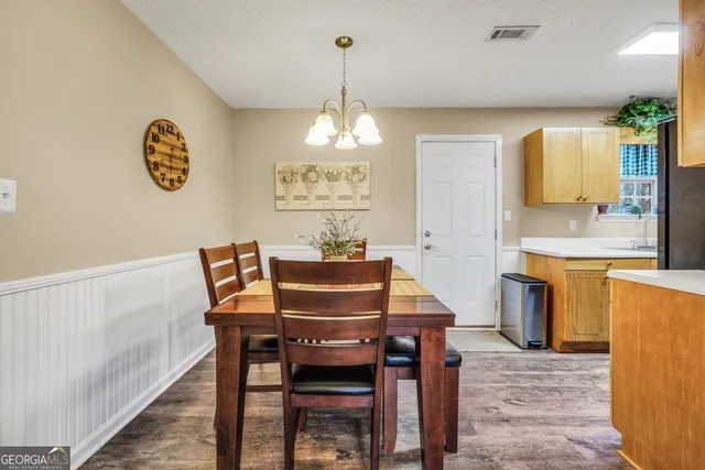 a dining room with furniture and window