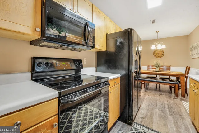 a kitchen with appliances and cabinets