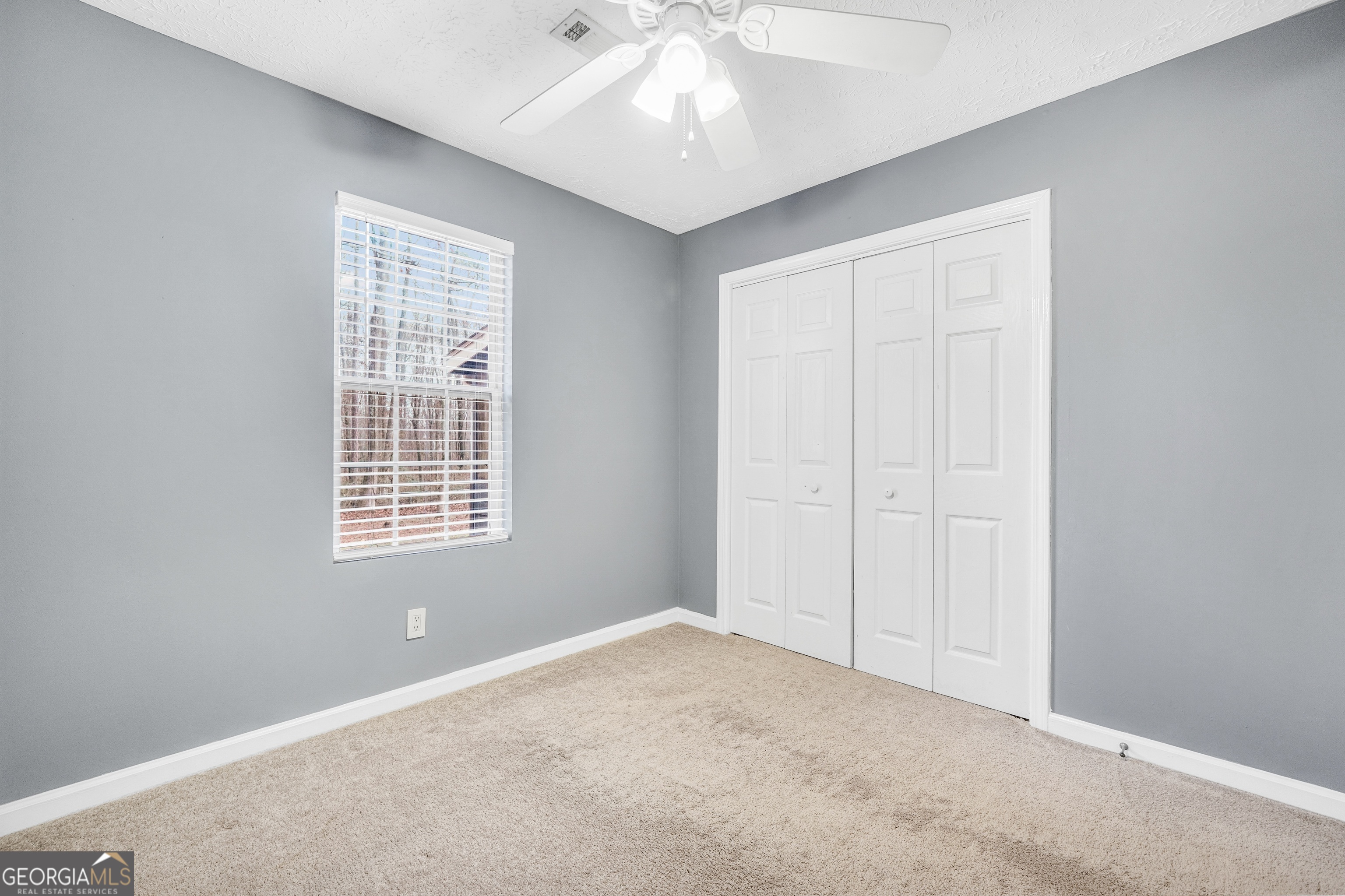 145 Old Highway 85 Senoia, GA 30276 - Photo 23 of 40 an empty room with windows and closet