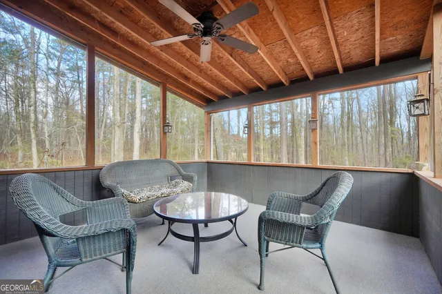 a balcony with furniture and a potted plant