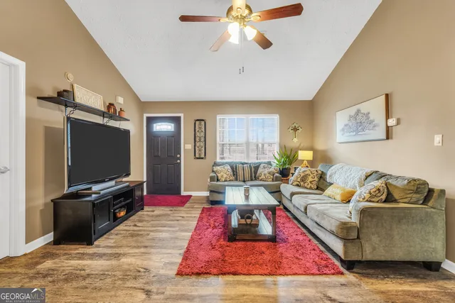a living room with furniture and a flat screen tv