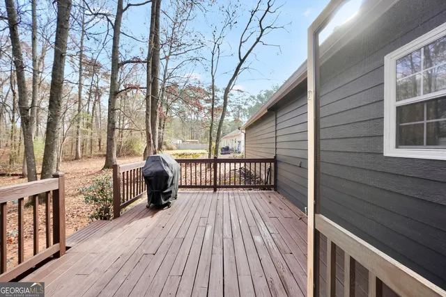 a view of balcony with wooden floor and outdoor seating