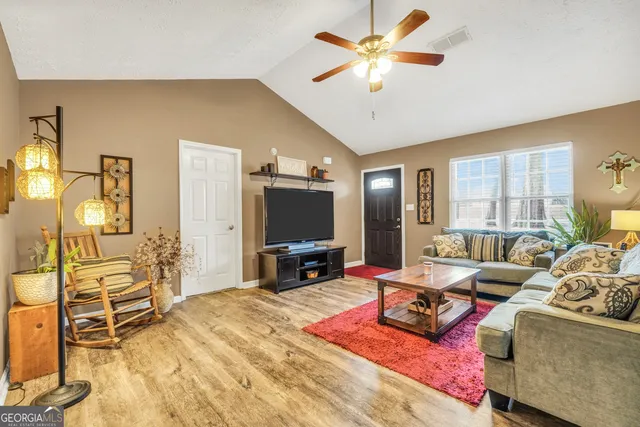 a living room with furniture and a flat screen tv