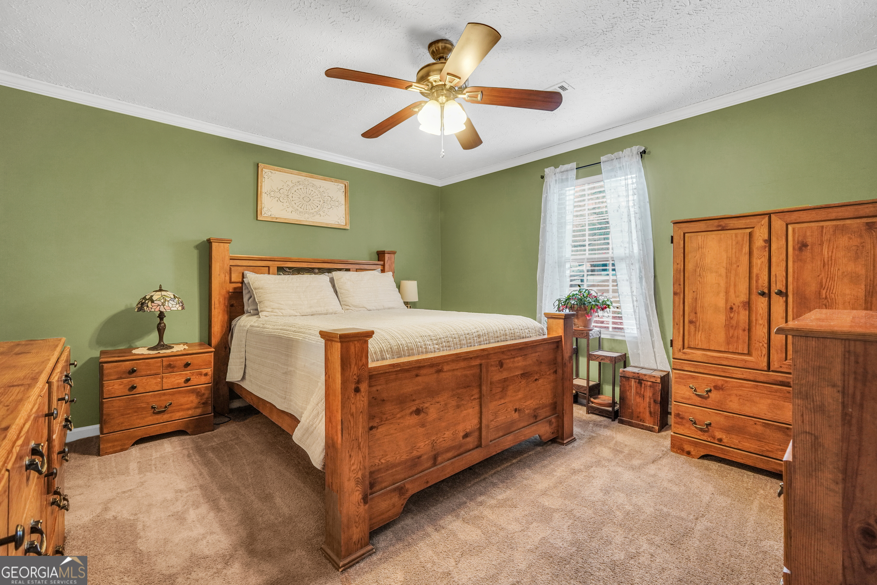 145 Old Highway 85 Senoia, GA 30276 - Photo 6 of 40 a bedroom with a bed and a chandelier