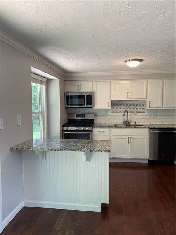 3124 Haberlein Road Gibsonia, PA 15044 - Photo 6 of 16 View of kitchen from dining room. Peninsula with granite counter and storage underneath. Space for a couple of counter stools too!