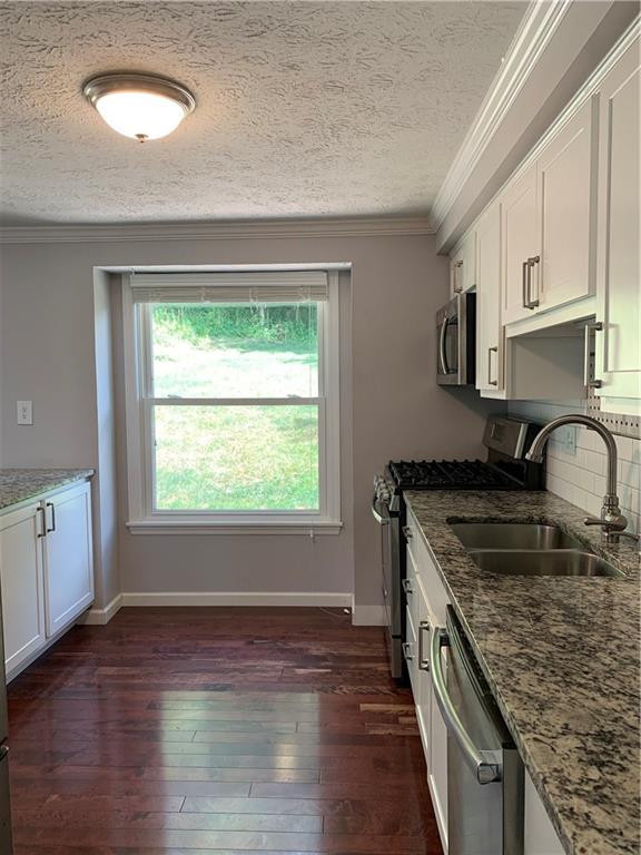 3124 Haberlein Road Gibsonia, PA 15044 - Photo 7 of 16 View of kitchen from front hallway. Granite tops, wood floor, stainless appliances and a big window overlooking the backyard.