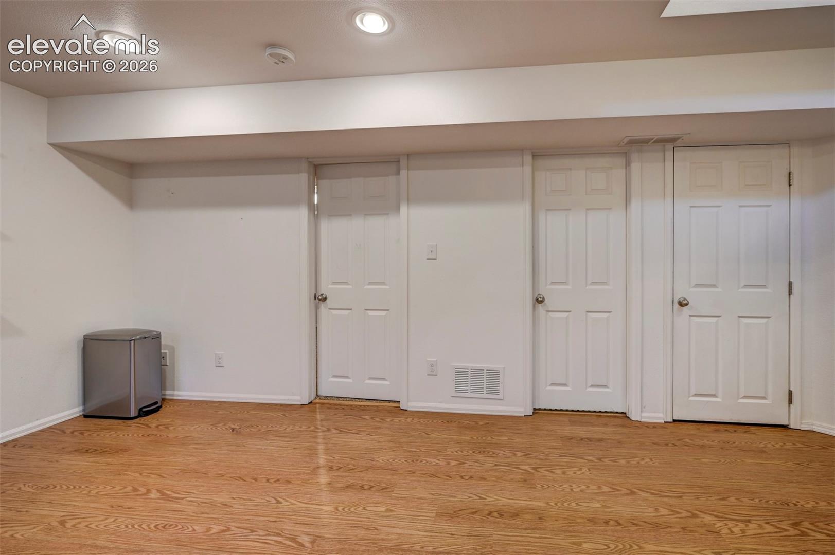 8170 Valli Farm Road Fountain, CO 80817 - Photo 28 of 50 Wood-finish flooring with recessed lighting, multiple paneled doors, and white walls