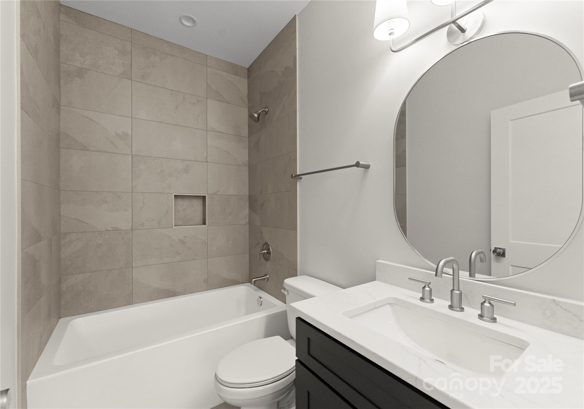 19405 Coachmans Trace Cornelius, NC 28031 - Photo 39 of 44 a bathroom with a granite countertop bathtub shower sink vanity mirror and toilet