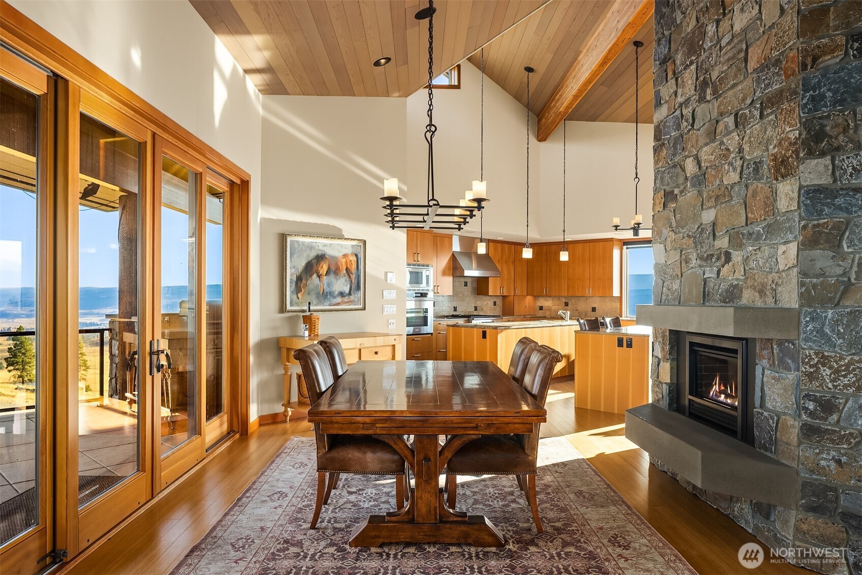 3653 Hart Road Cle Elum, WA 98922 - Photo 15 of 40 a dining room with furniture a fireplace and wooden floor