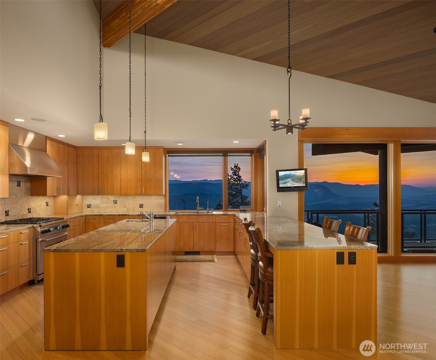 3653 Hart Road Cle Elum, WA 98922 - Photo 17 of 40 a view of a kitchen with kitchen island stainless steel appliances wooden floor dining table and chairs