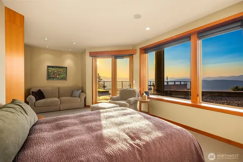 a large bedroom with a large bed and a large window