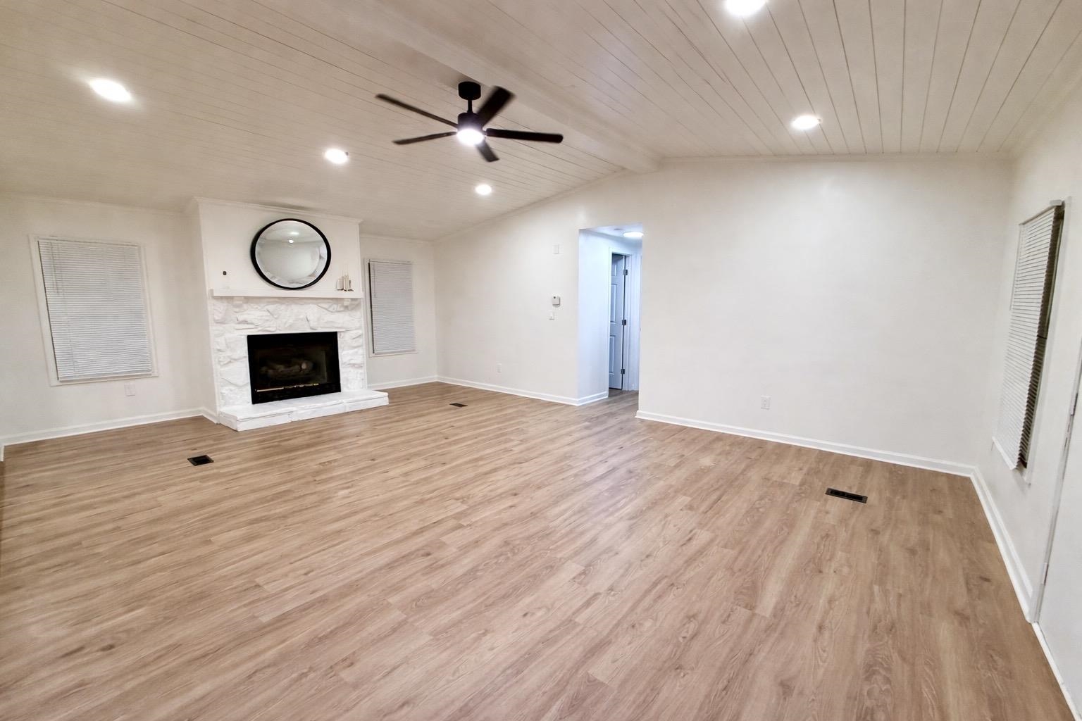 800 Highway 59 Mason, TN 38049 - Photo 5 of 11 a view of an empty room with wooden floor fireplace and a window