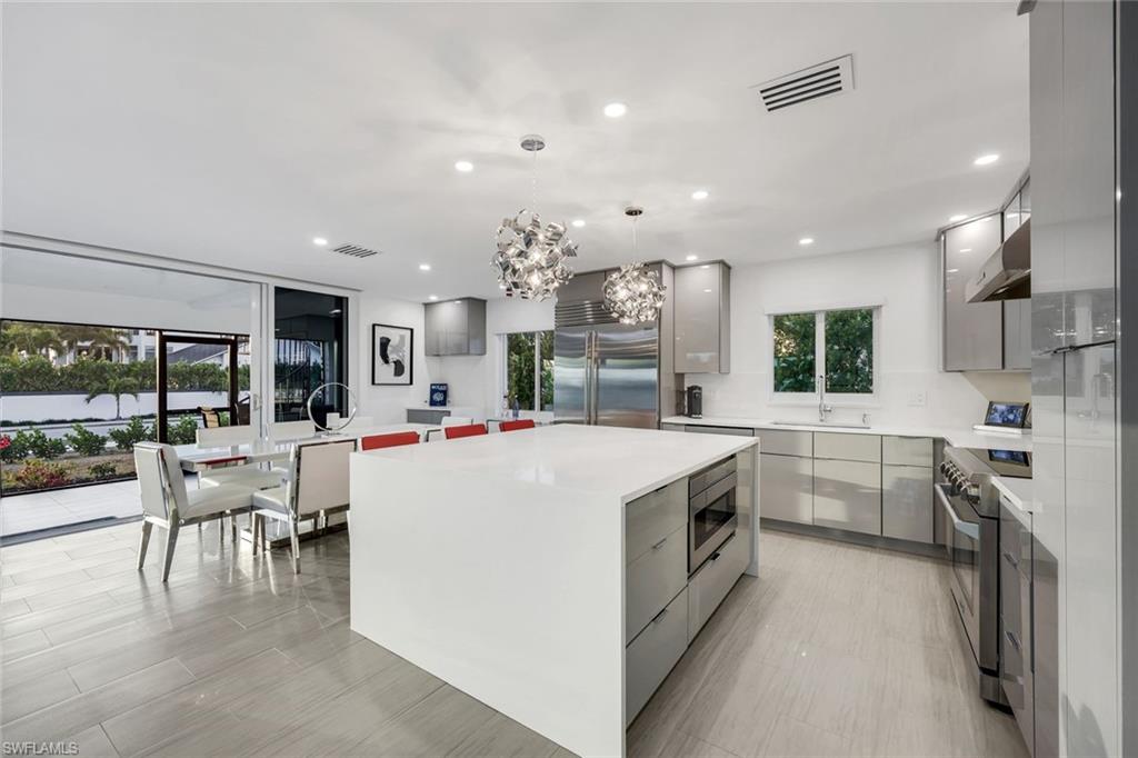 10002 Vanderbilt Drive Naples, FL 34108 - Photo 11 of 42 Seamless flow from kitchen to dining