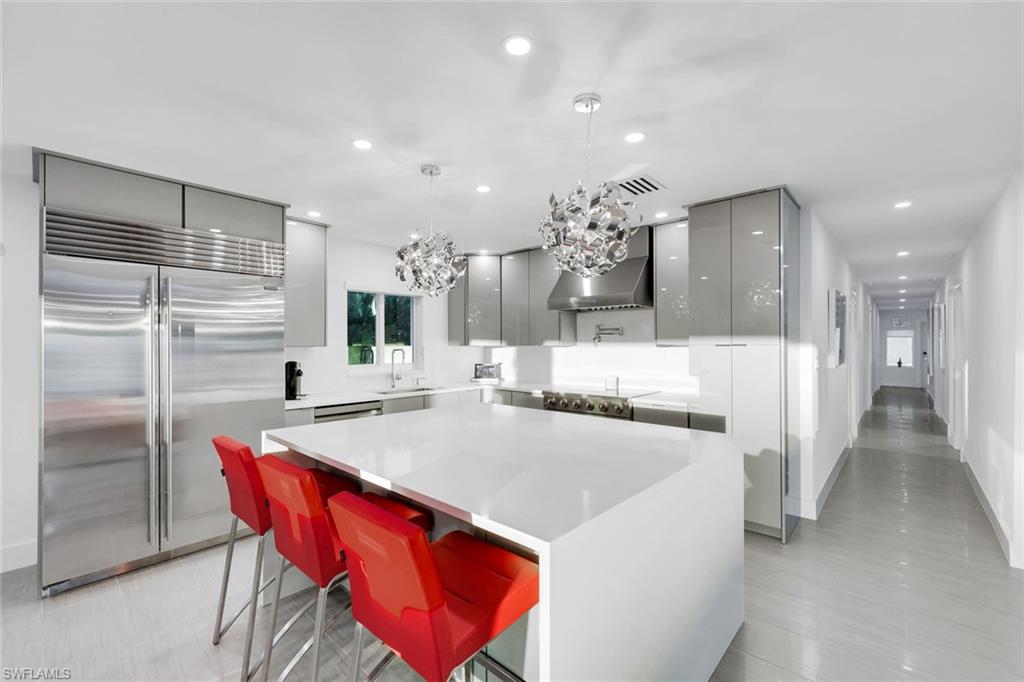 10002 Vanderbilt Drive Naples, FL 34108 - Photo 13 of 42 White, gray, and stainless steel kitchen