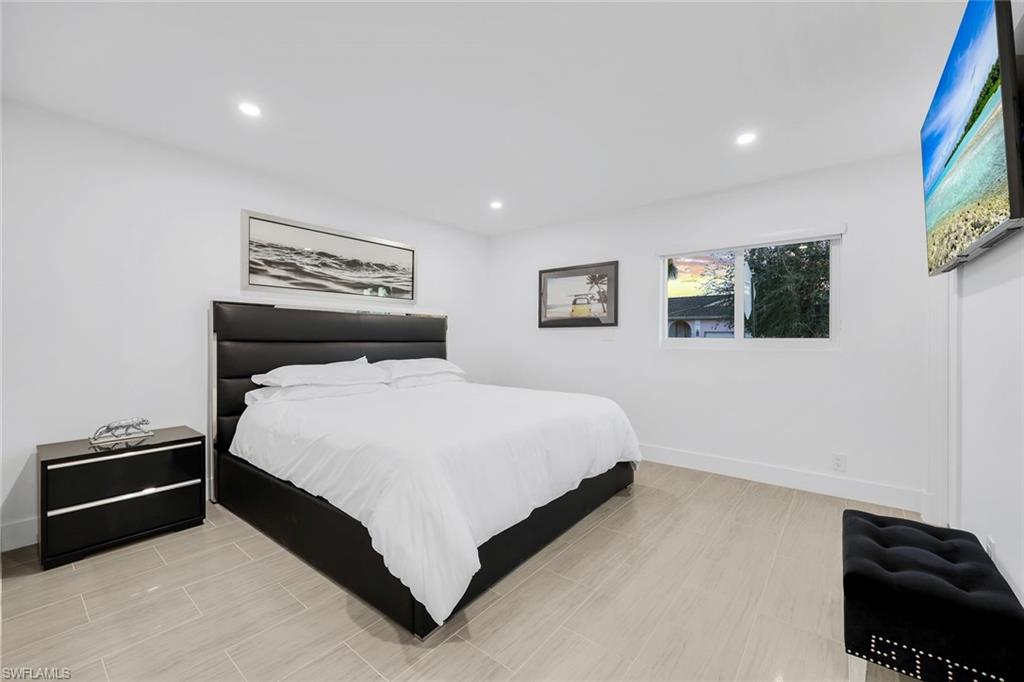 10002 Vanderbilt Drive Naples, FL 34108 - Photo 16 of 42 Spacious White and earth tone bedroom.